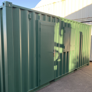 green converted shipping container with latham's door and window shutter